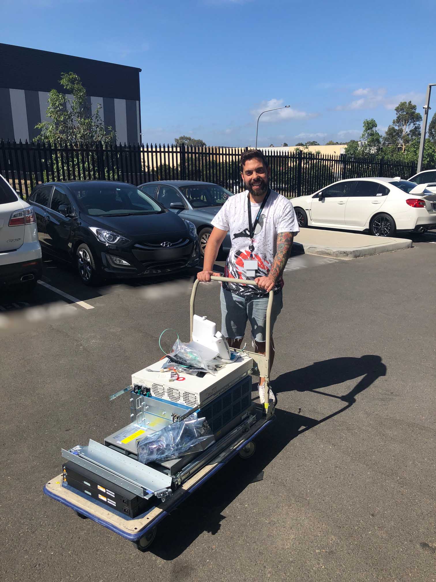 a man pushing hardware on a trolley