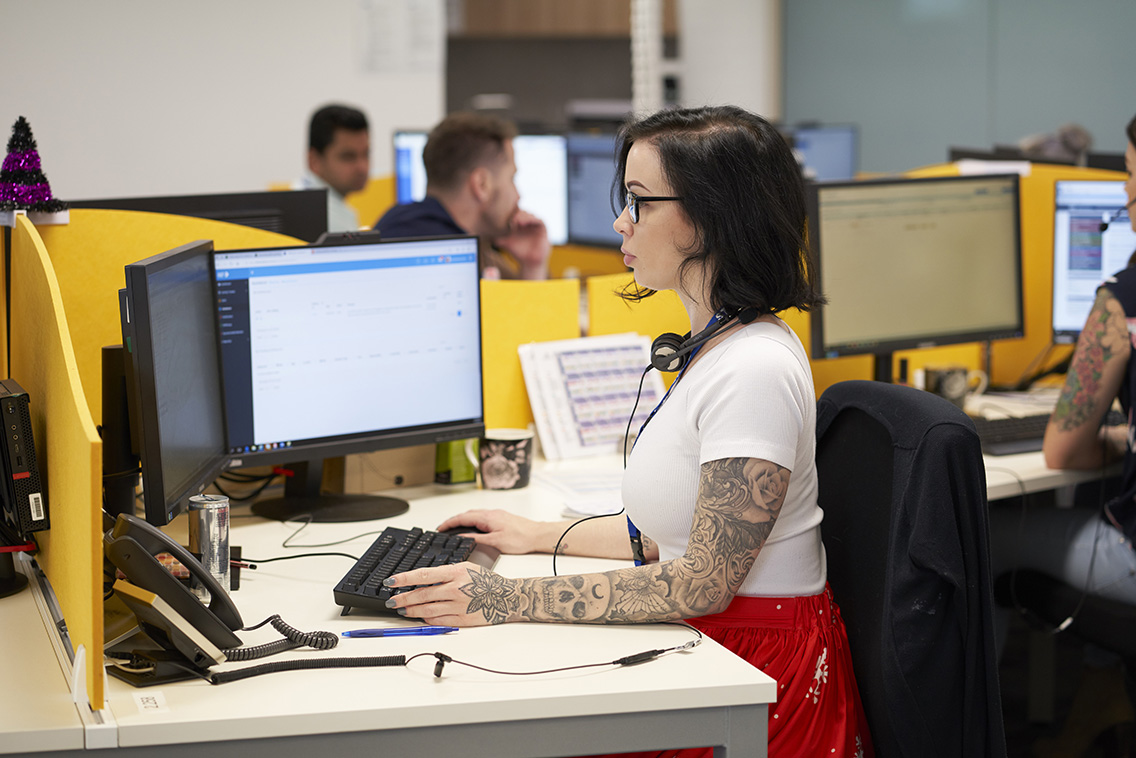 young lady with tattoo and headset